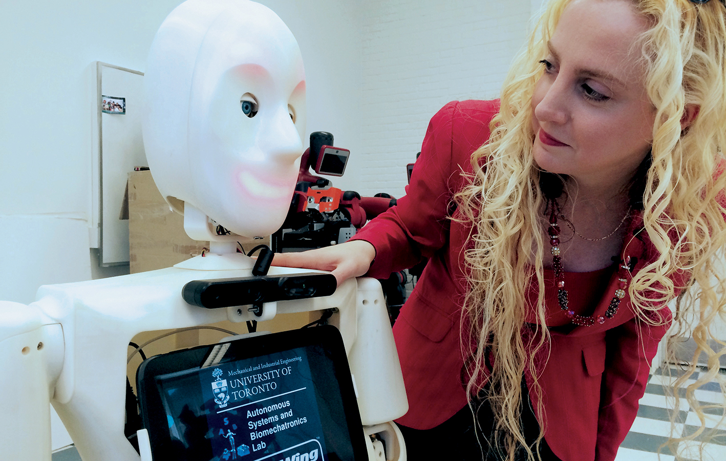Goldie Nejat (1) Goldie Nejat looking at Casper the Robot, who is built to assist in the home.